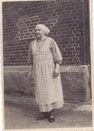 Selma standing in front of brick building