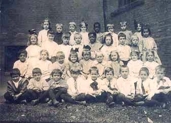 Bertha as a child with lots of other children