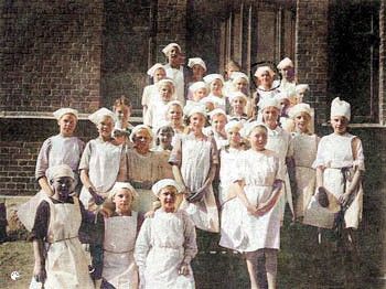 Bertha standing in nurses uniform with group