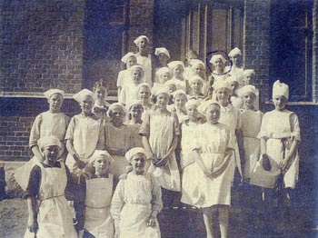 Bertha standing in nurses uniform with group