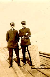 Philip on deck of a ship with another man