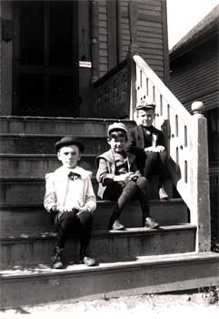 Philip with two boys sitting on steps