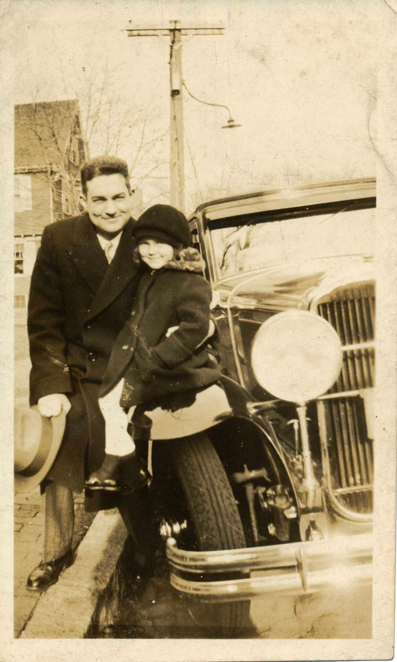 Philip with Arlene beside a car